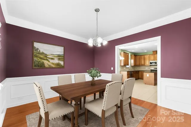 a view of a dining room with furniture and chandelier