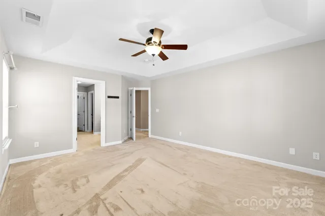 a view of a livingroom with a ceiling fan and window