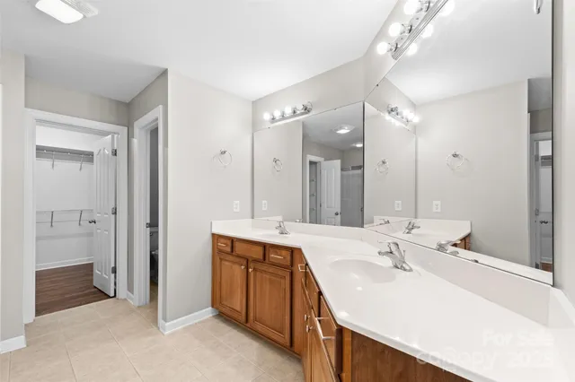 a bathroom with a sink double vanity and a mirror