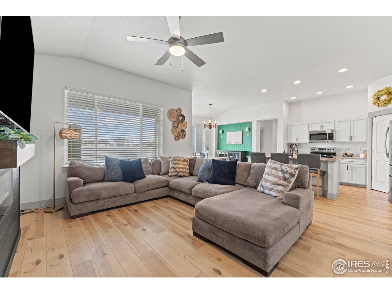 1216 Muskox Street Severance, CO 80550 - Photo 13 of 37 a living room with furniture and a flat screen tv