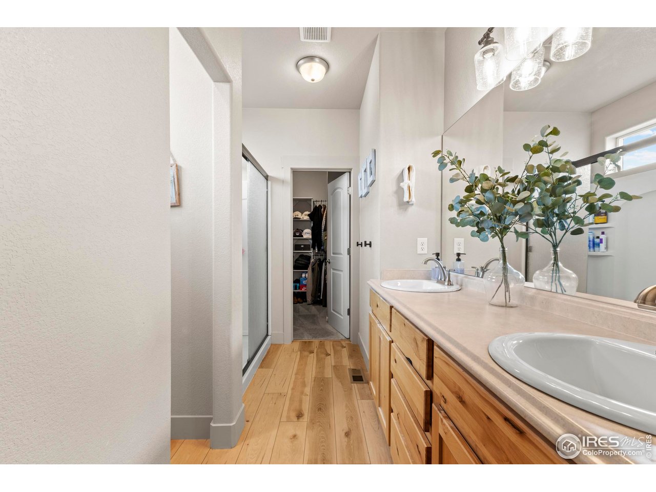 1216 Muskox Street Severance, CO 80550 - Photo 18 of 37 a bathroom with a sink double vanity granite and a shower