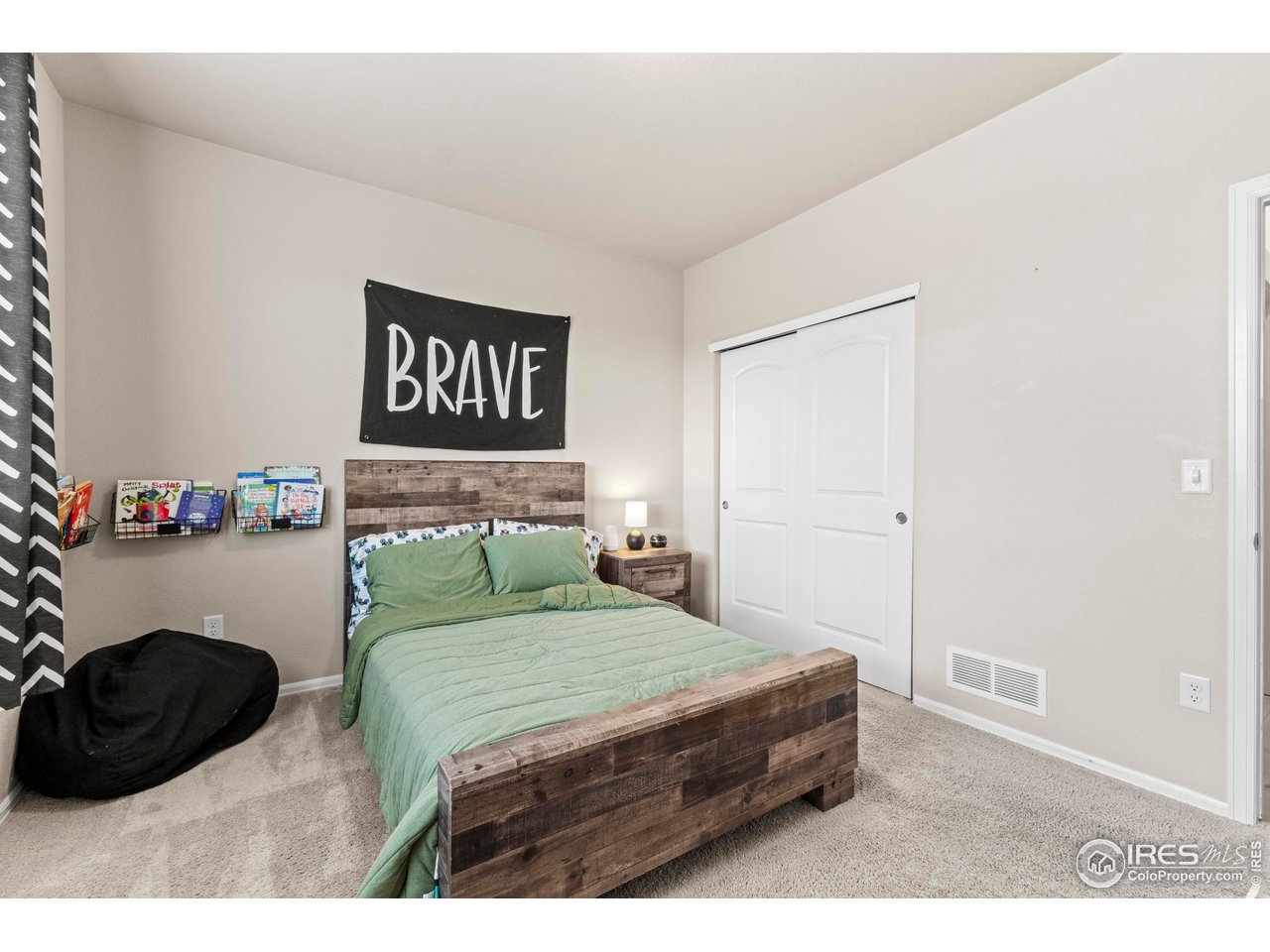 1216 Muskox Street Severance, CO 80550 - Photo 20 of 37 a bedroom with a bed and a chair