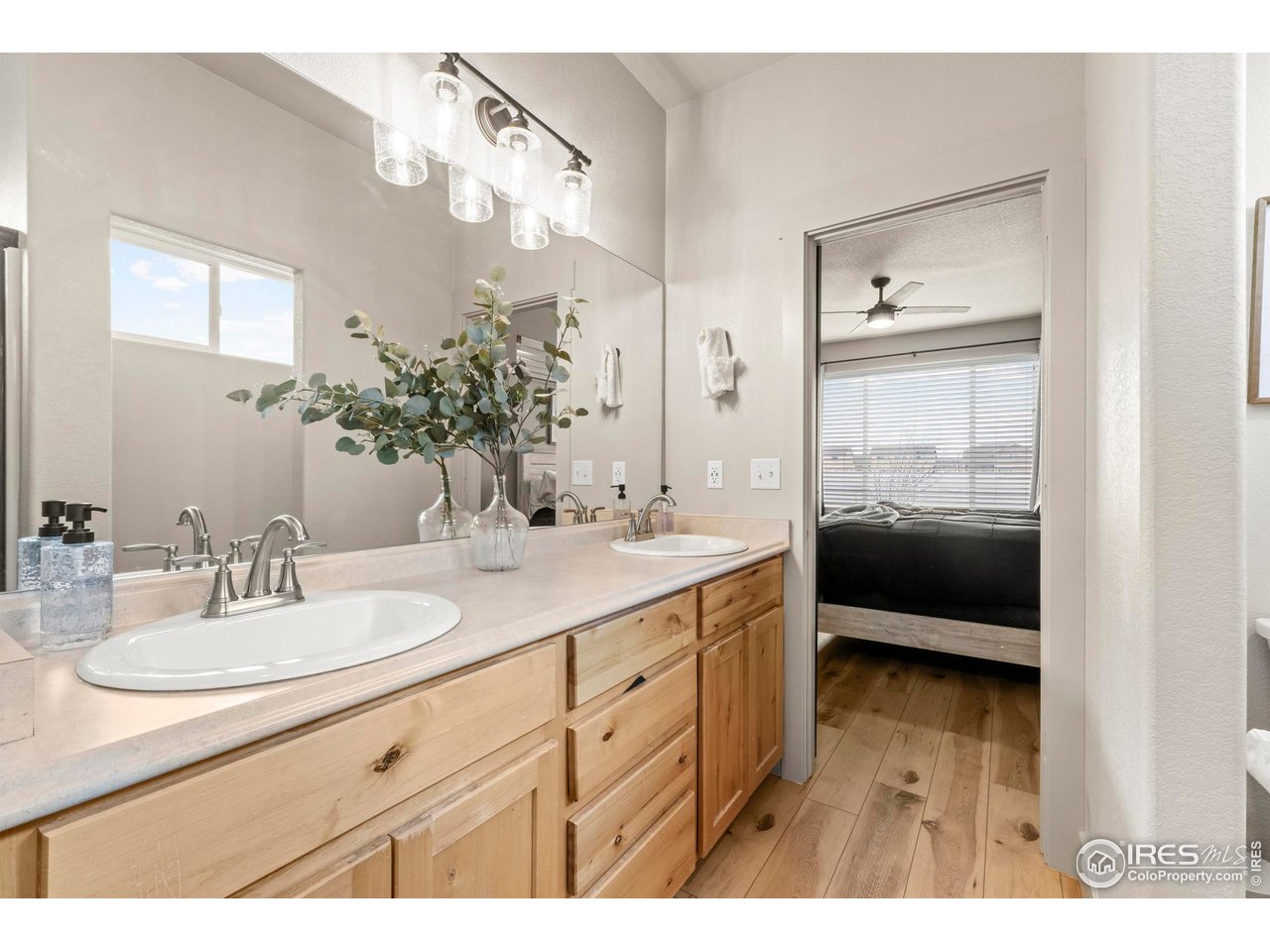1216 Muskox Street Severance, CO 80550 - Photo 24 of 37 a en suite bathroom with a double vanity sink and mirror