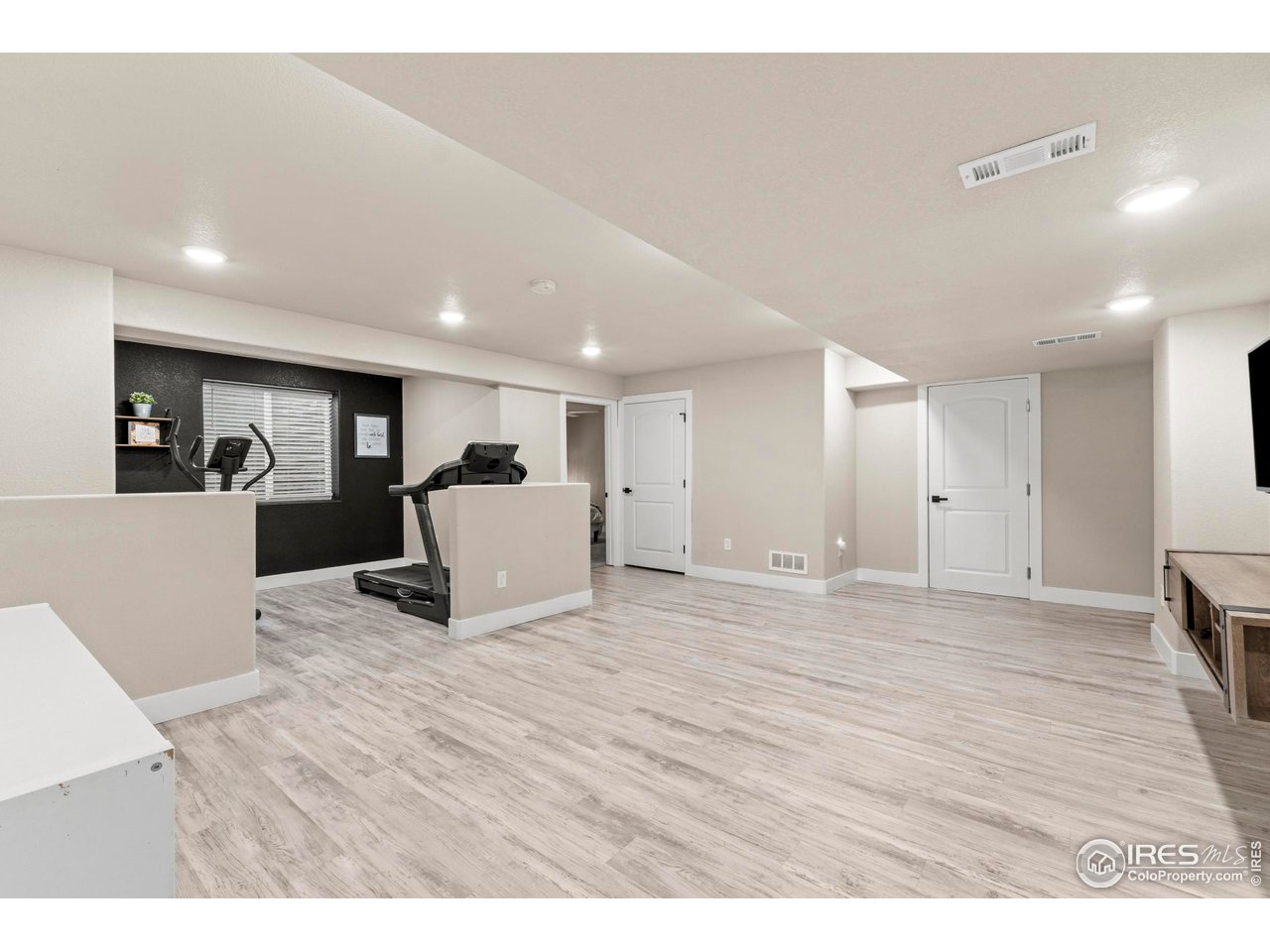1216 Muskox Street Severance, CO 80550 - Photo 27 of 37 a view of a living room a wooden floor and kitchen