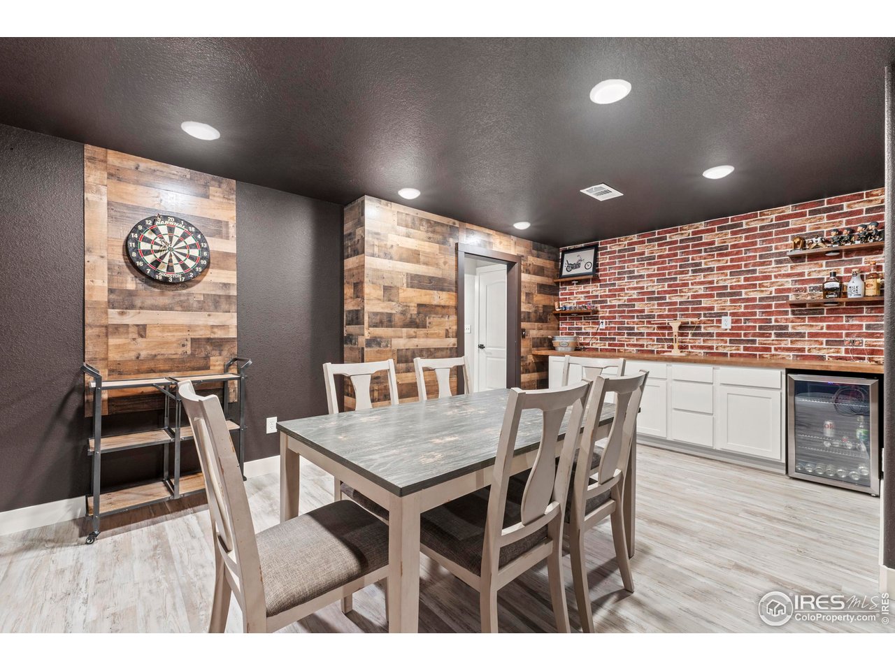 1216 Muskox Street Severance, CO 80550 - Photo 29 of 37 a view of a dining room with furniture window and wooden floor