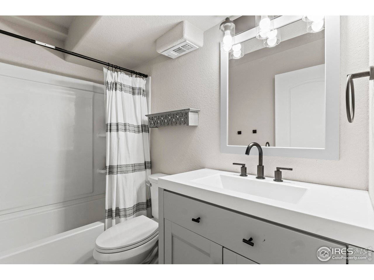 1216 Muskox Street Severance, CO 80550 - Photo 31 of 37 a bathroom with a sink double vanity and a mirror