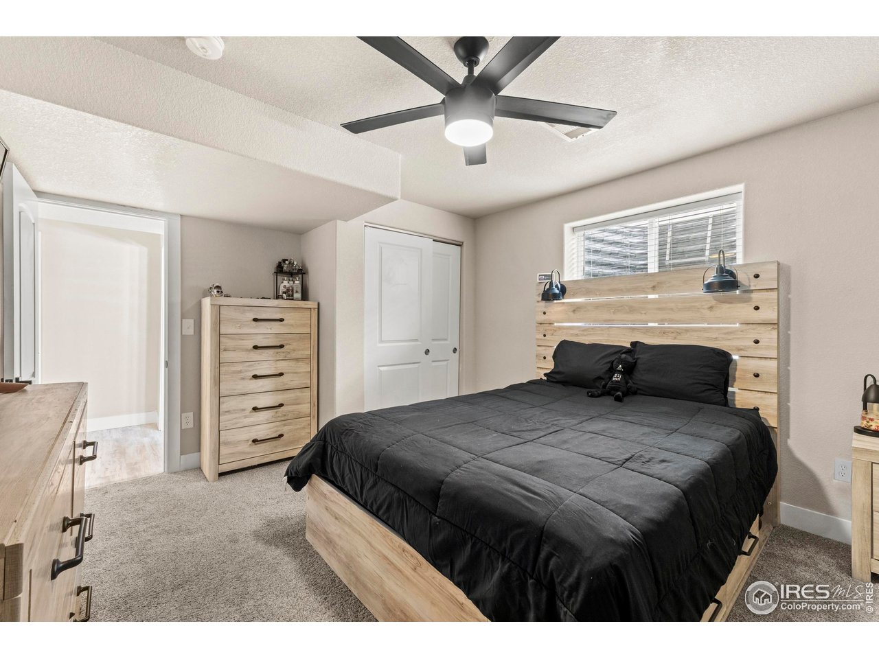 1216 Muskox Street Severance, CO 80550 - Photo 33 of 37 a bedroom with a large bed and a tv