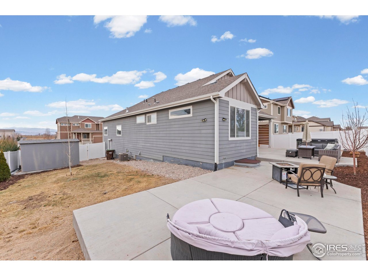 1216 Muskox Street Severance, CO 80550 - Photo 35 of 37 a view of a backyard with table and chairs