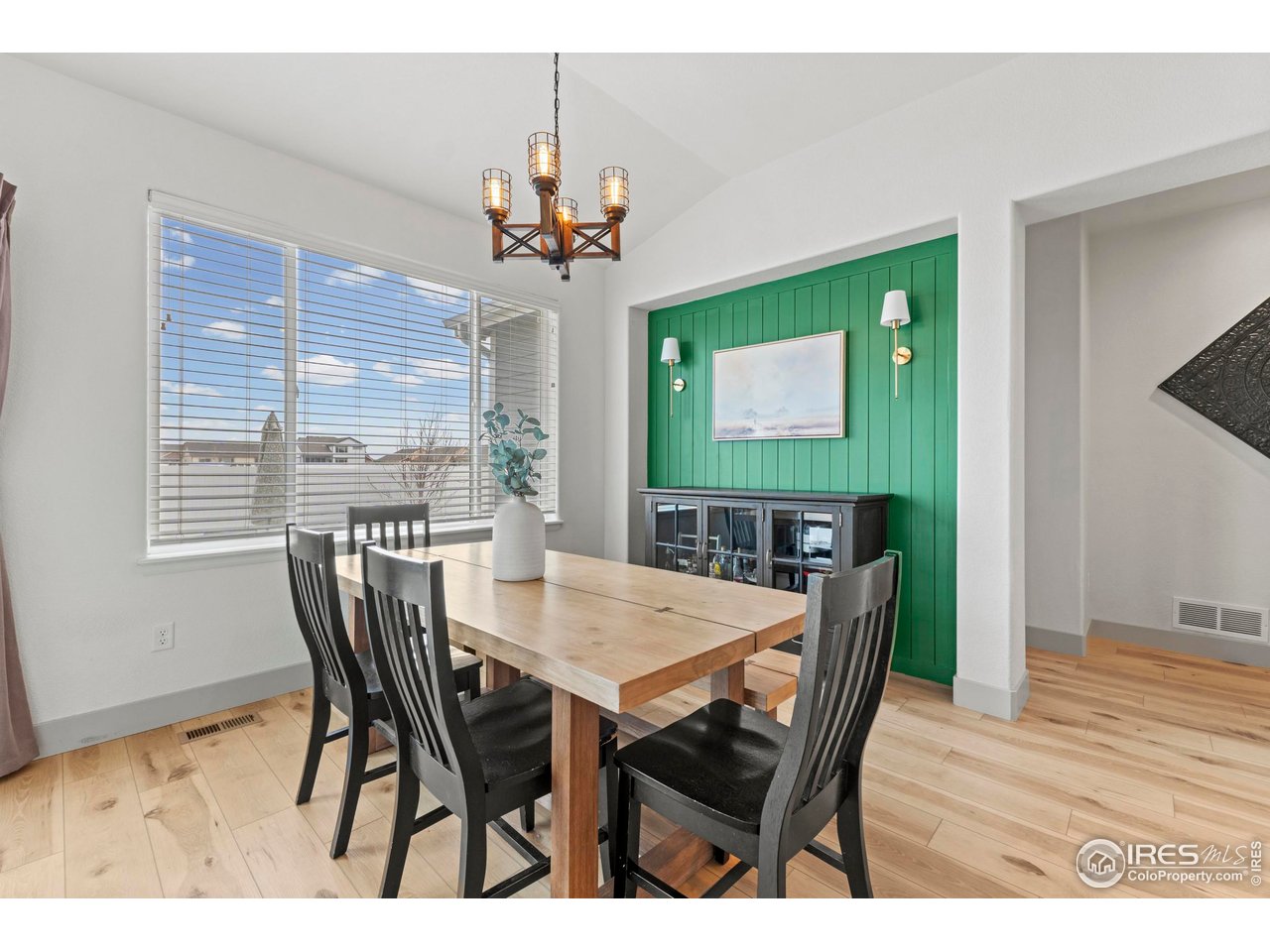 1216 Muskox Street Severance, CO 80550 - Photo 7 of 37 a view of a dining room with furniture window and wooden floor
