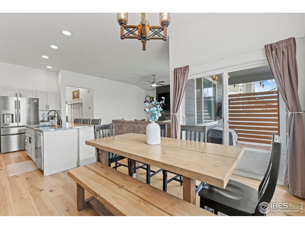 1216 Muskox Street Severance, CO 80550 - Photo 8 of 37 a living room with furniture and wooden floor