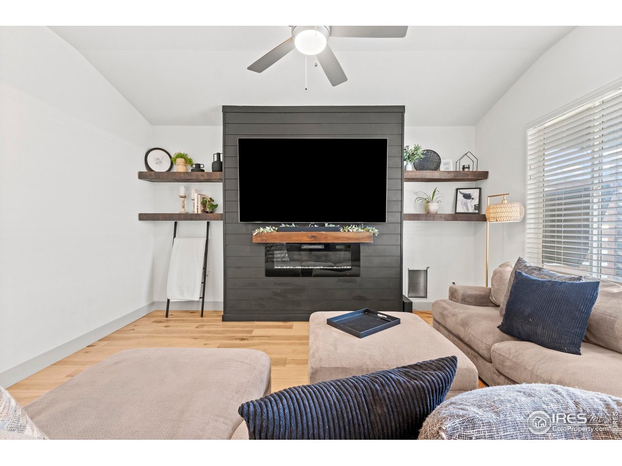 1216 Muskox Street Severance, CO 80550 - Photo 10 of 37 a living room with furniture and a flat screen tv