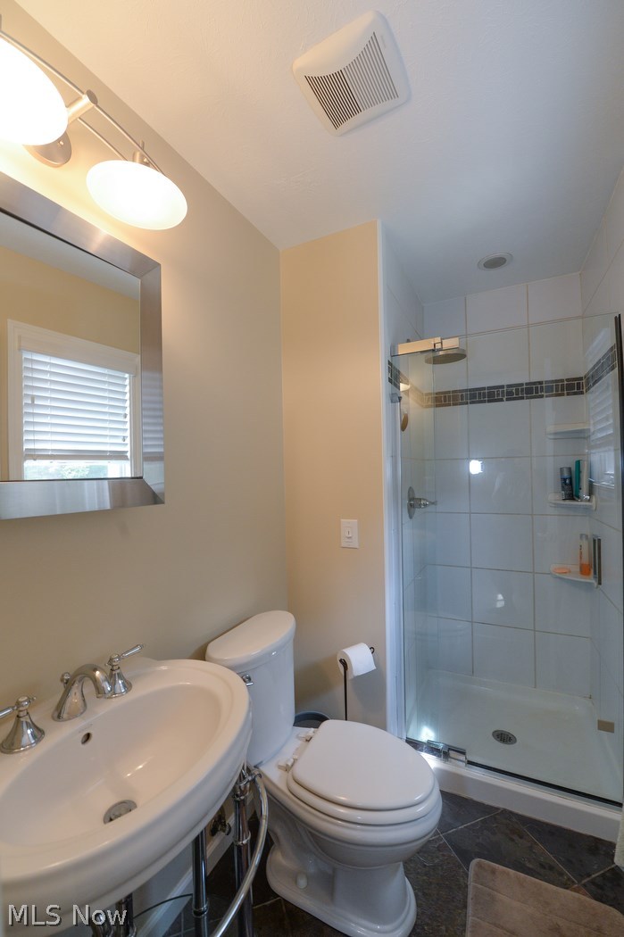 347 Silver Ridge Drive Akron, OH 44321 - Photo 12 of 31 This master bathroom is completely updated with ceramic tile flooring, a tile shower and pedestal sink!
