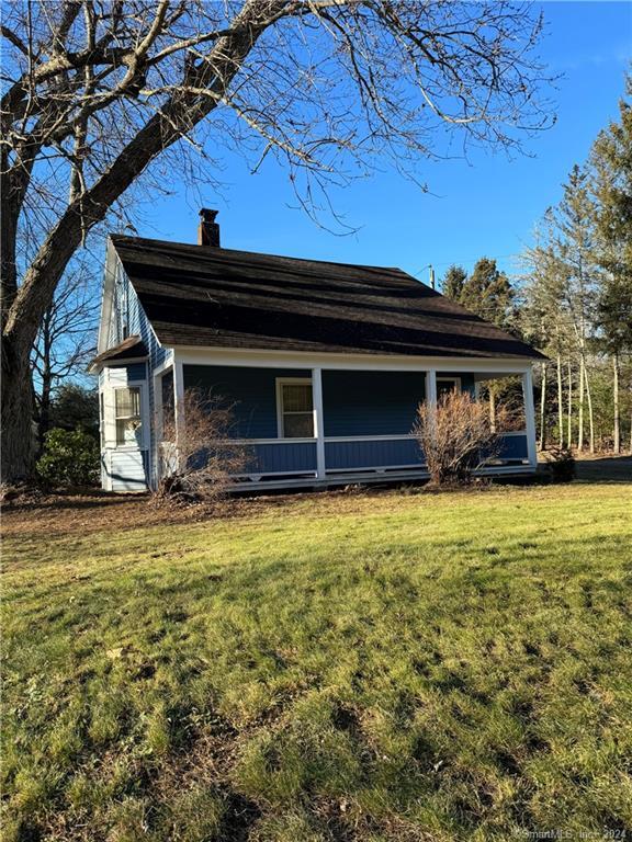 128 Willimantic Road Chaplin, CT 06235 - Photo 1 of 1 a front view of a house with a garden