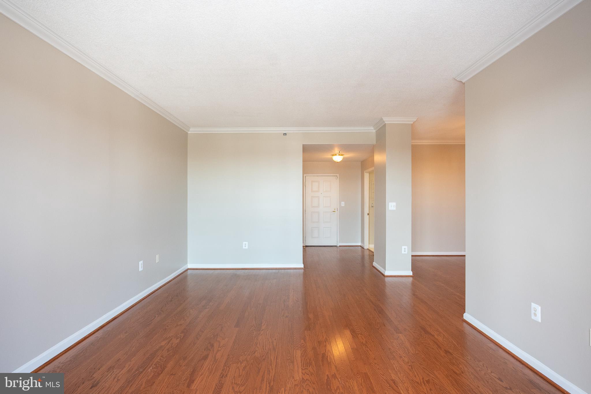 3200 North Leisure World Boulevard, Unit 1007 Silver Spring, MD 20906 - Photo 14 of 36 a view of an empty room with wooden floor
