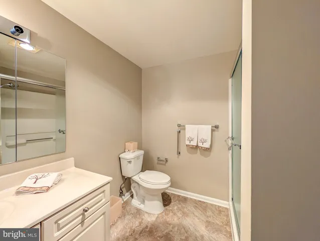 a bathroom with a toilet a sink and shower
