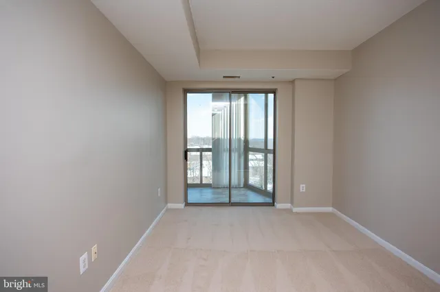 an empty room with large windows