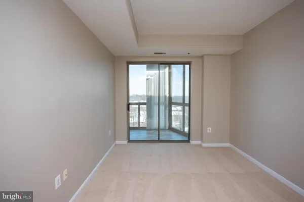 an empty room with large windows