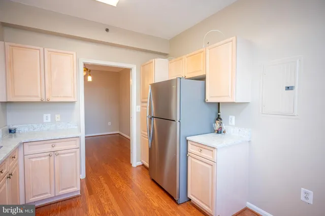 a kitchen with a refrigerator sink and cabinets