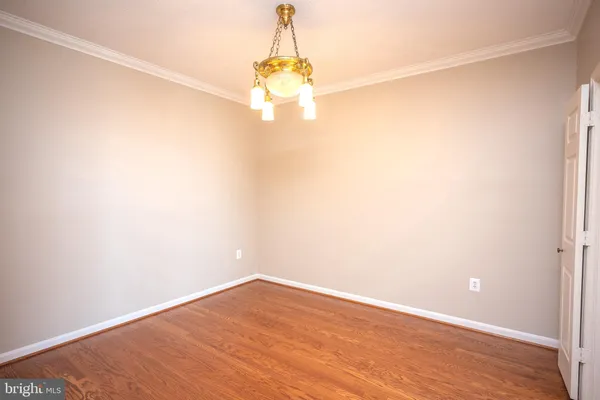 a view of a small space with wooden floor and a window