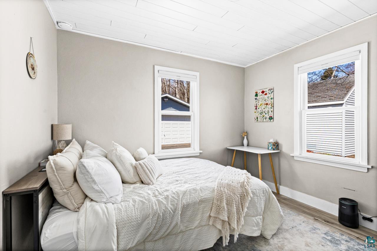3645 Haines Road Hermantown, MN 55811 - Photo 31 of 35 Light gray painted walls define this space, featuring white trim and wood-finish plank flooring