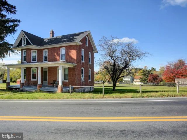 a view of a big building with a big yard and plants