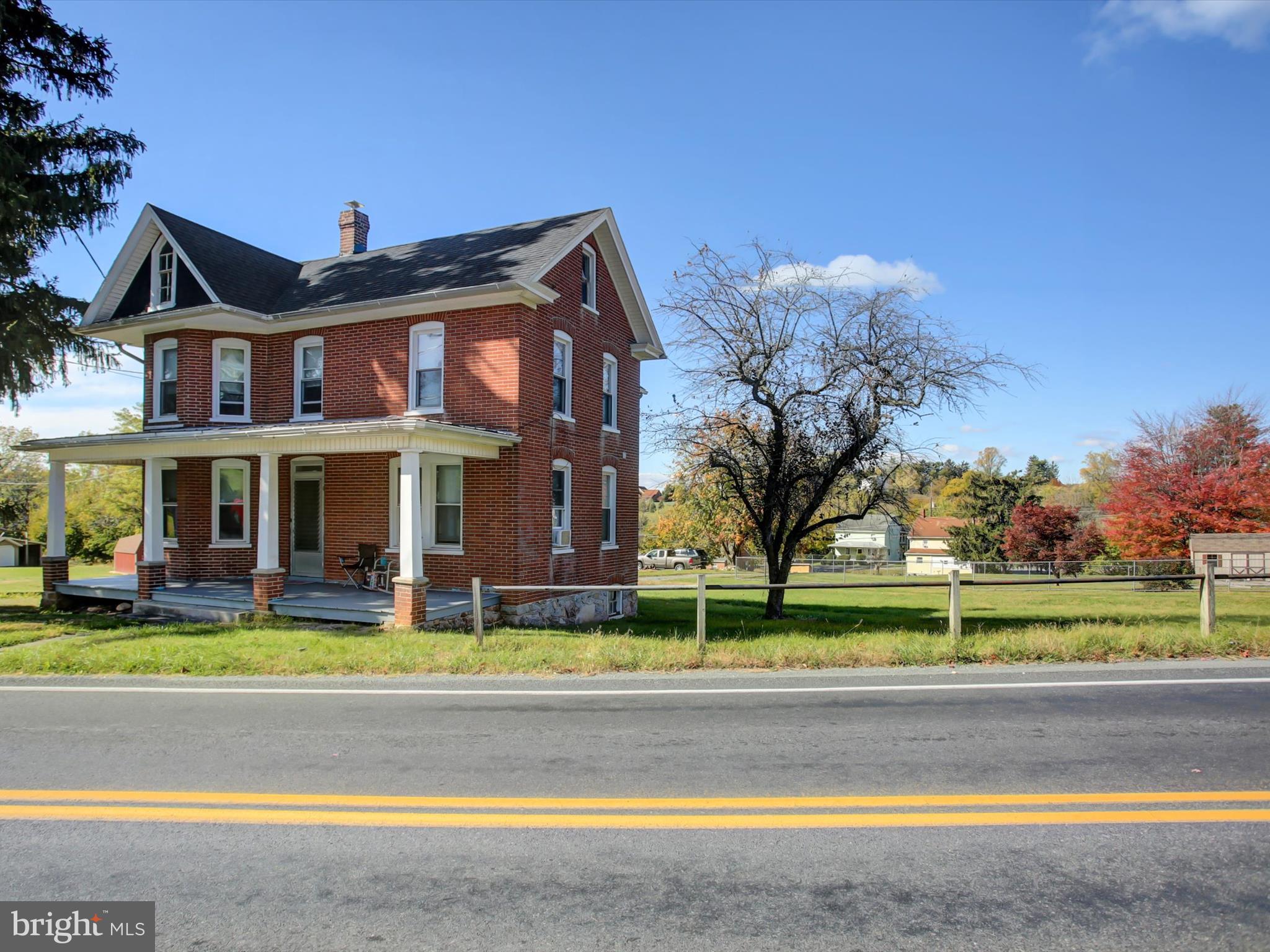a view of a big building with a big yard and plants