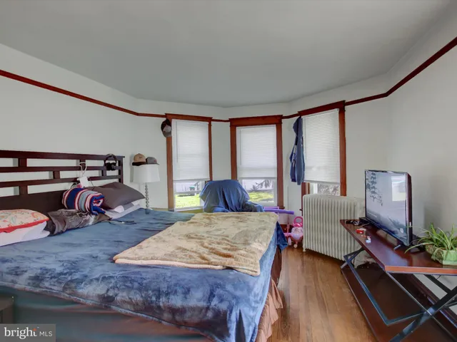 a bedroom with furniture and a large window