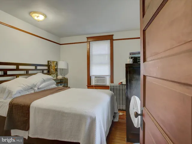 a bedroom with two beds and a large window