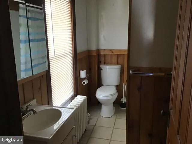 a bathroom with a toilet sink and tub