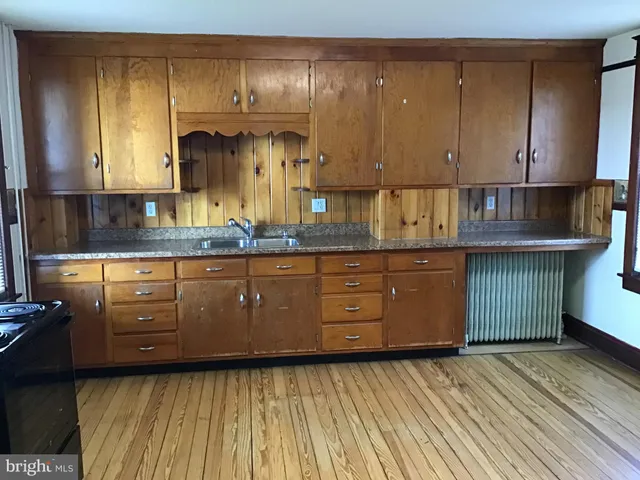 a kitchen with a sink a cabinets and window