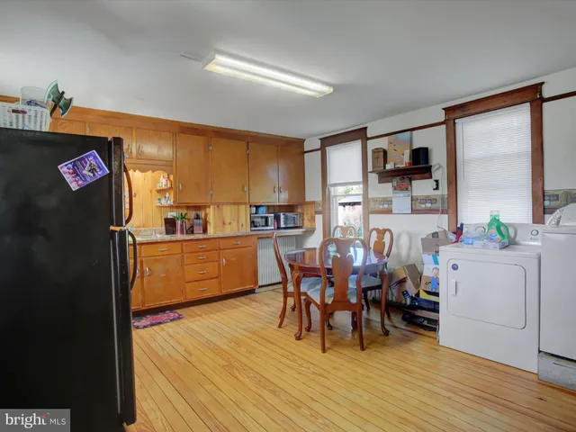 a dining room with furniture and wooden floor