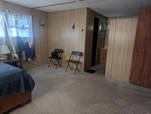 a bed room with a bed and a mirror