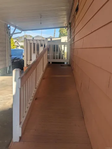 a view of a porch with wooden floor and stairs