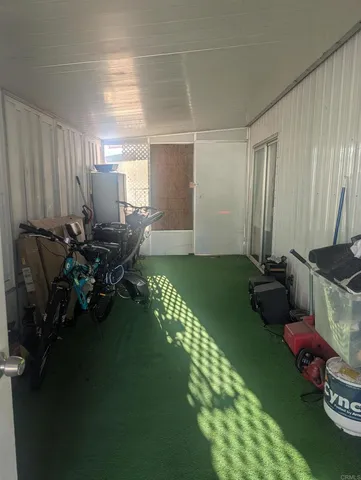 a room with lots of wooden furniture a chandelier and a dining table