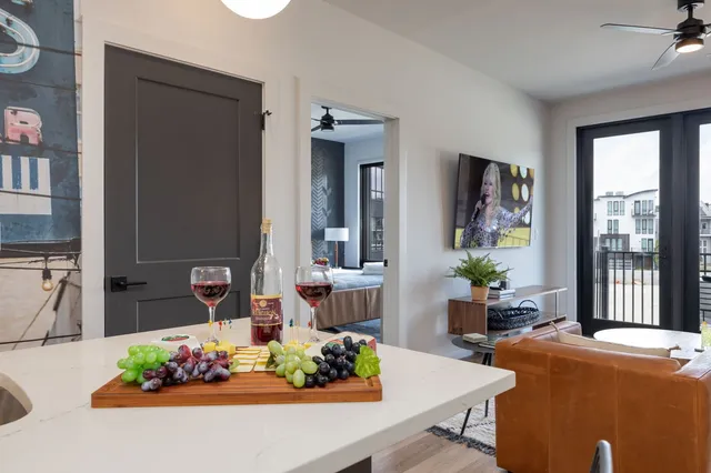 a living room with furniture and a potted plant