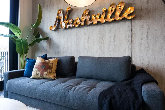 a bed sitting in a bedroom next to a cabinet