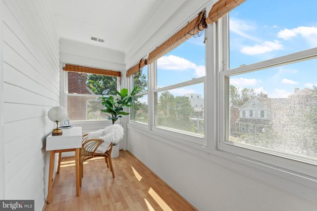 a view of a room with a table and chairs and a potted plant