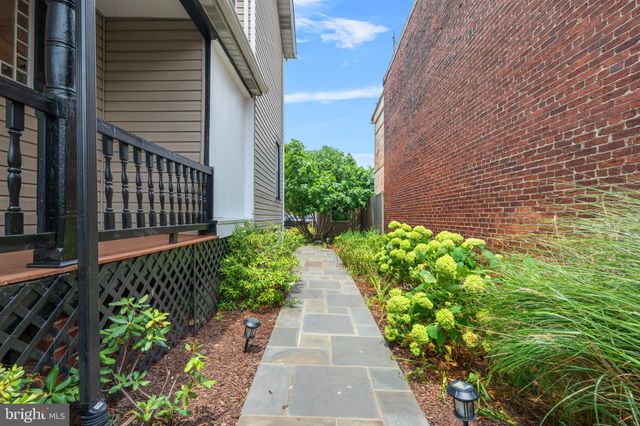 a view of a pathway with flower pots