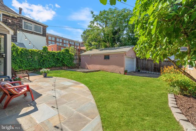 a view of backyard with swimming pool and patio