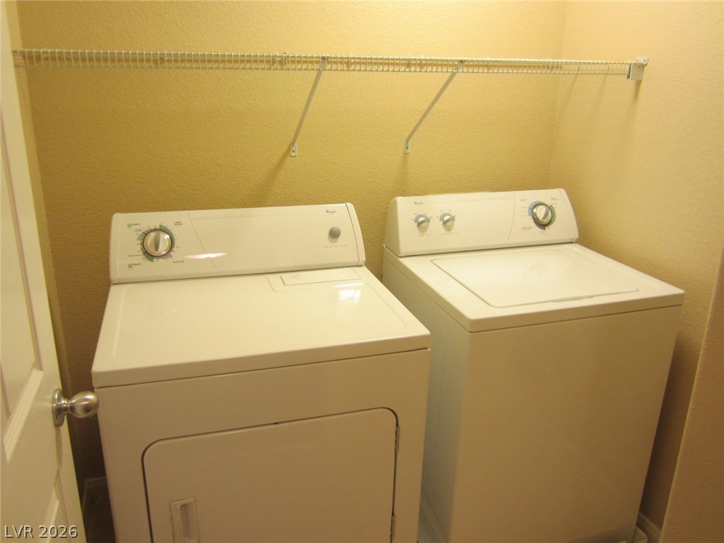 7701 West Robindale Road, Unit 262 Las Vegas, NV 89113 - Photo 21 of 26 A well-equipped laundry space with convenient shelving above modern appliances.