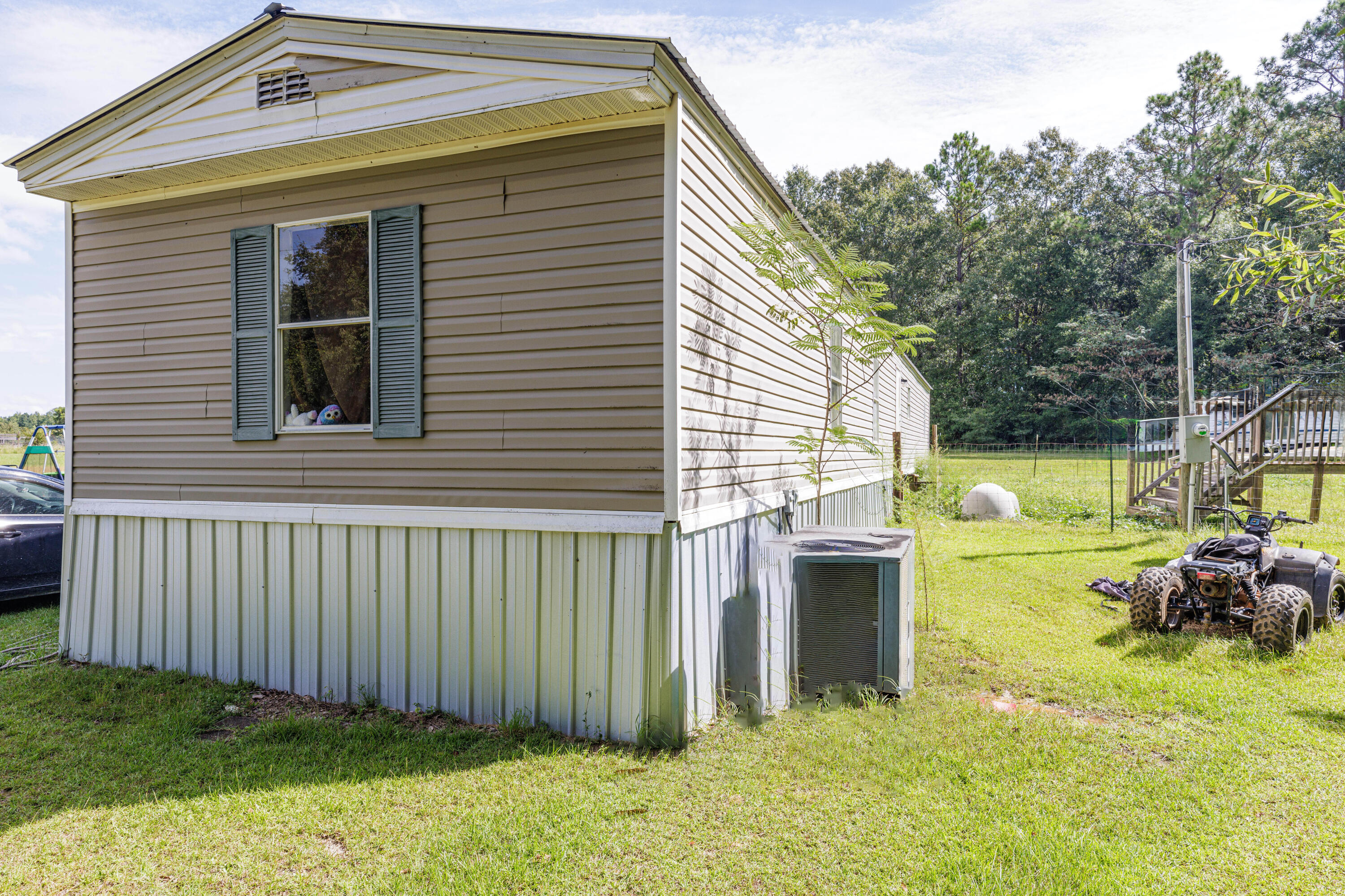 6337 Sherman Kennedy Road Baker, FL 32531 - Photo 17 of 17 a view of a house with a backyard and porch