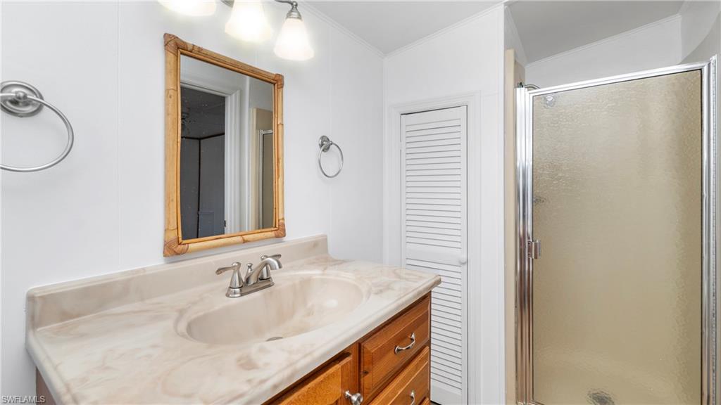 171 Grassy Key Lane Naples, FL 34114 - Photo 13 of 25 a bathroom with a sink and a mirror