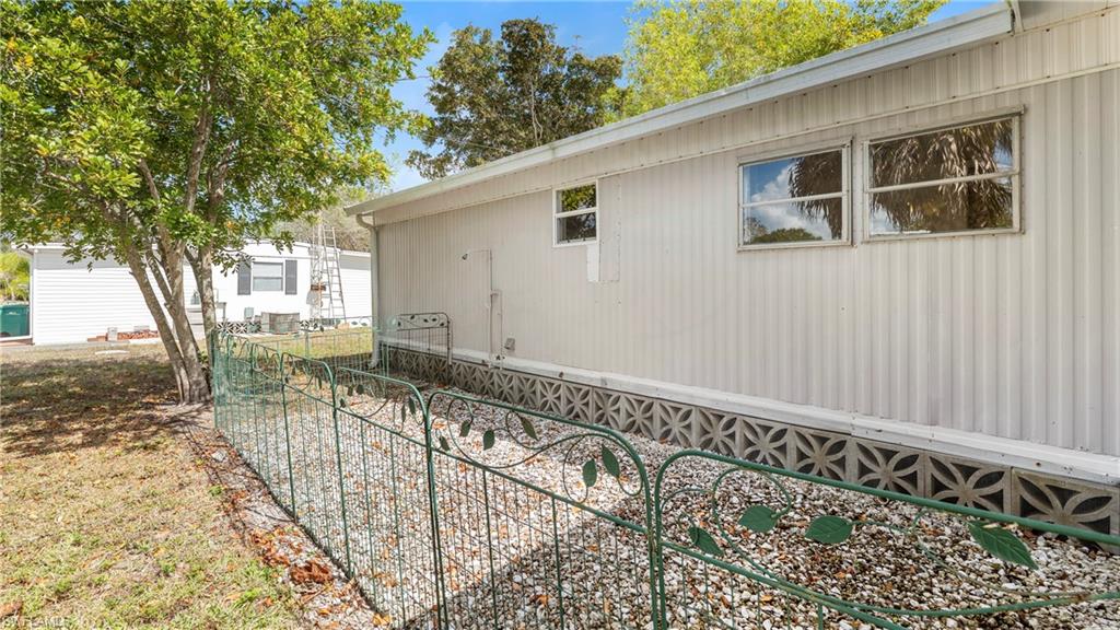 171 Grassy Key Lane Naples, FL 34114 - Photo 17 of 25 a view of a house with a wooden bench