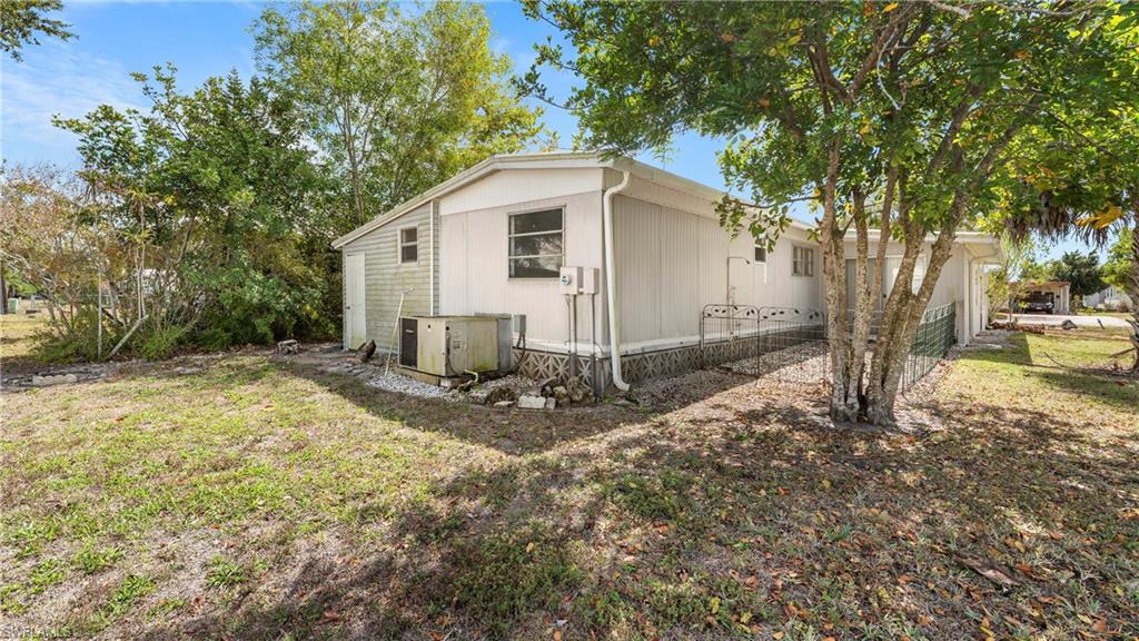 171 Grassy Key Lane Naples, FL 34114 - Photo 18 of 25 a view of a backyard with large tree and plants