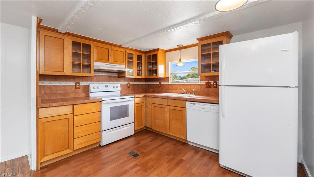 171 Grassy Key Lane Naples, FL 34114 - Photo 2 of 25 a kitchen with stainless steel appliances granite countertop a refrigerator a stove and a sink