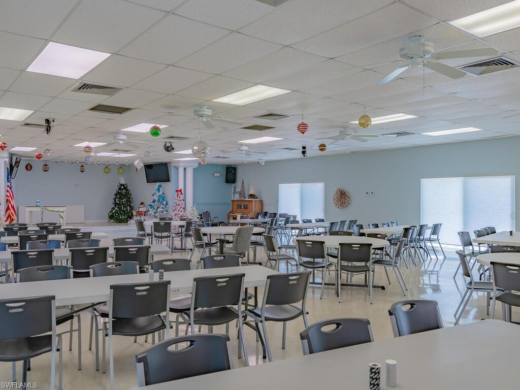 171 Grassy Key Lane Naples, FL 34114 - Photo 23 of 25 a group of people sitting around in a living room