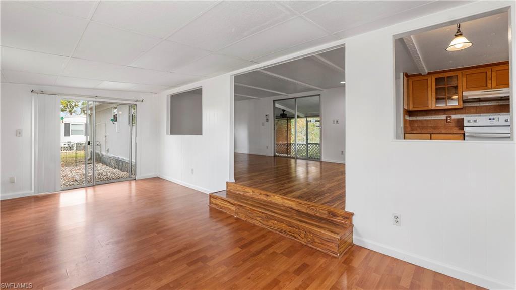 171 Grassy Key Lane Naples, FL 34114 - Photo 3 of 25 wooden floor in an empty room with a window