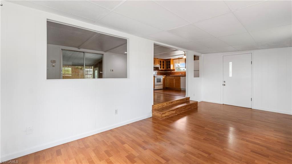 171 Grassy Key Lane Naples, FL 34114 - Photo 4 of 25 a view of empty room with wooden floor