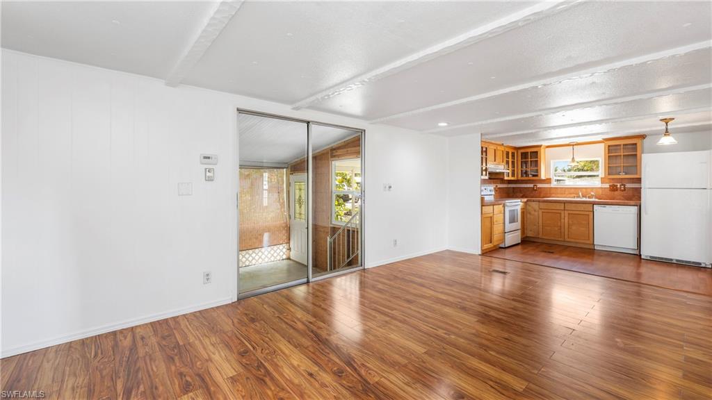 171 Grassy Key Lane Naples, FL 34114 - Photo 5 of 25 a view of a kitchen with a sink and a refrigerator