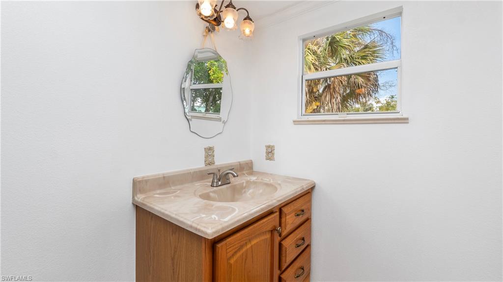 171 Grassy Key Lane Naples, FL 34114 - Photo 9 of 25 a bathroom with a sink and a mirror